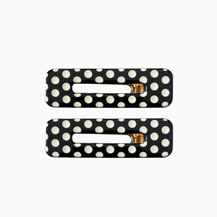 Angled view of Black And White Dot Hair Clips in rectangle shape, easy for workdays and special occasions.
