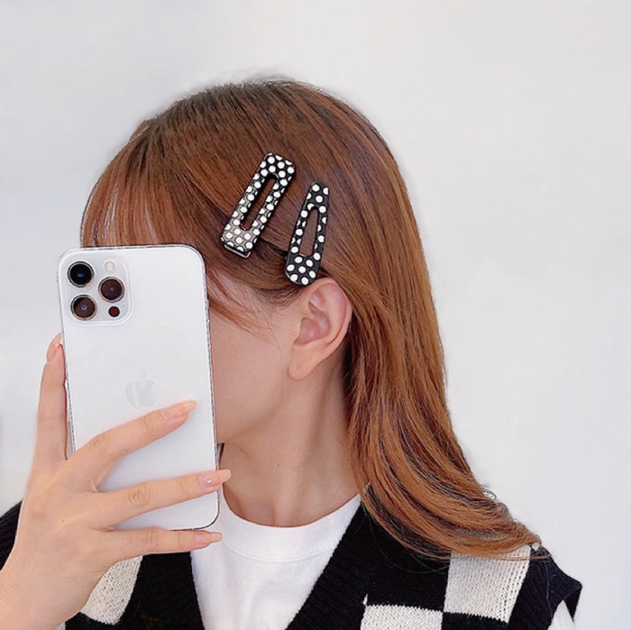 Model wearing two Black And White Dot Hair Clips , great for everyday styling and gifting.