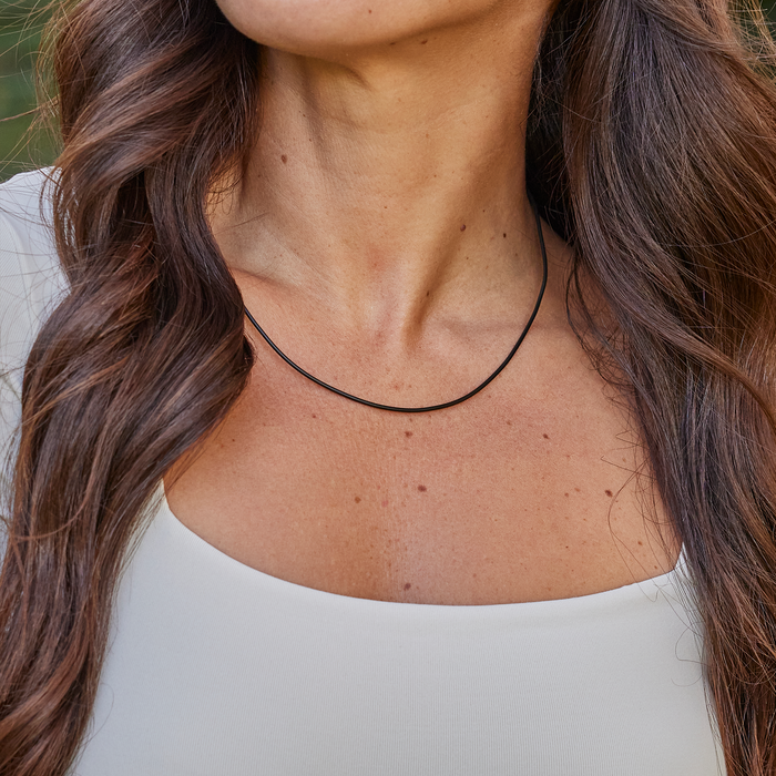 Womanʻs neckline wearing Black Rubber Cord Chain in Sterling Silver