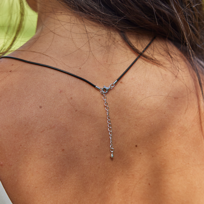 Close up of adjustable chain on the back of the Black Rubber Cord Chain in Sterling Silver on a woman