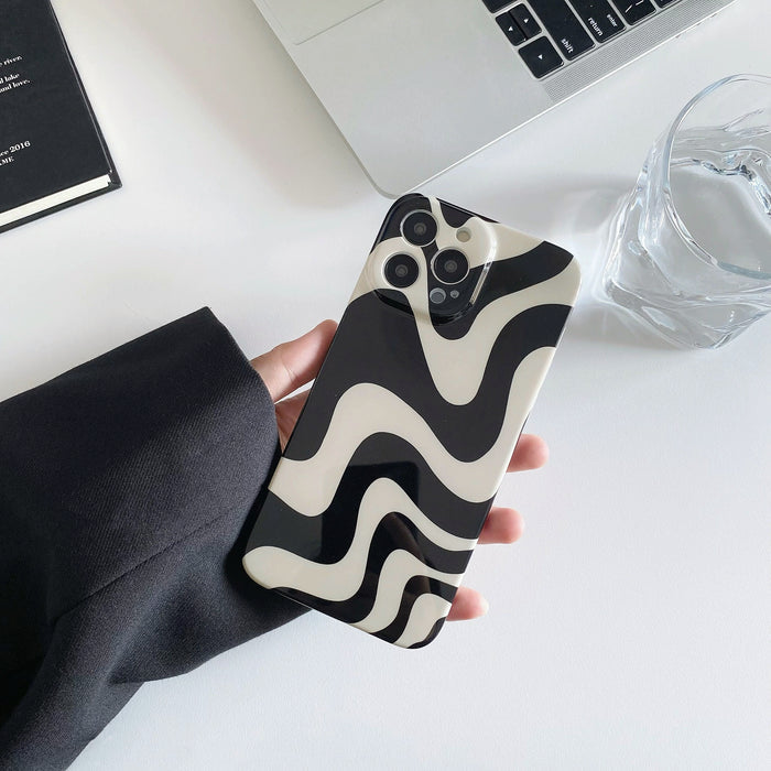 Model holding Black Wave Phone Case. Sleek wave-texture finish in durable acrylic, perfect for modern edgy fashion.