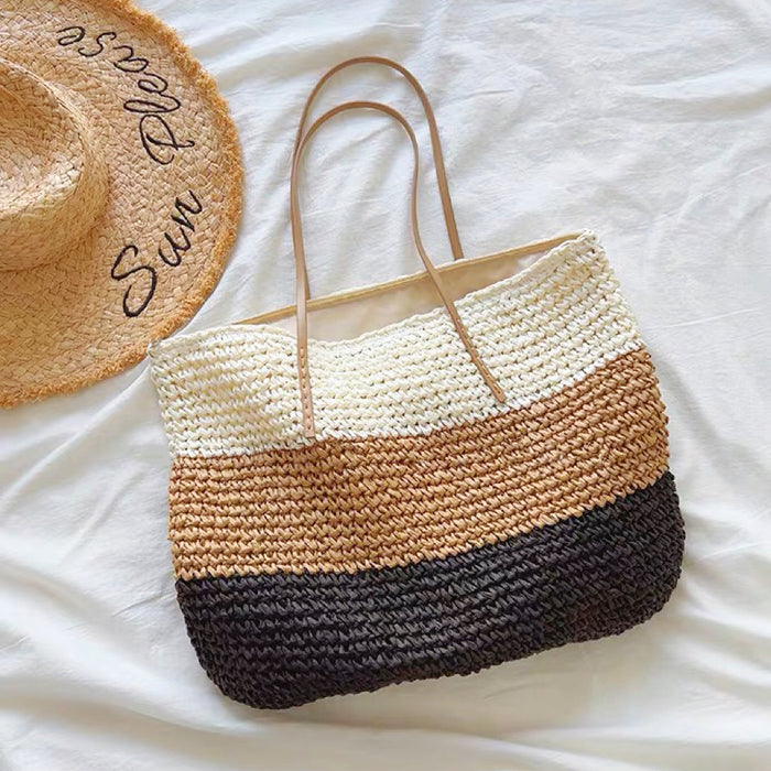Front view of Bohemia straw tote bag with white, brown, and black horizontal stripes, and tan PU leather straps.