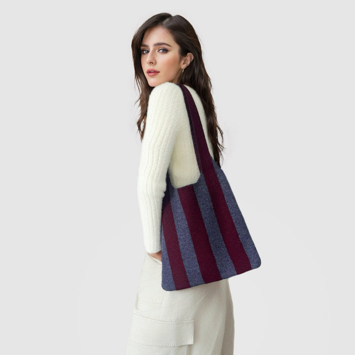 Model carrying a maroon wool bag on the shoulder, easy for commuting and weekends.