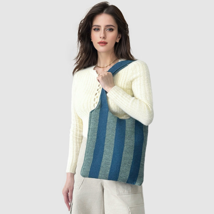 Model carrying a blue wool bag as crossbody, great for daily carry and travel.