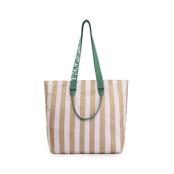 Flat lay of Bold Color Striped Tote Bag in khaki, great for everyday carry and travel.