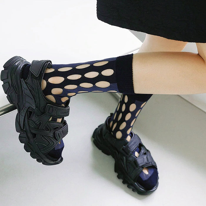 Model wearing a pair of  Bold Hollow Socks in dark blue, great for daily wear and lounging.