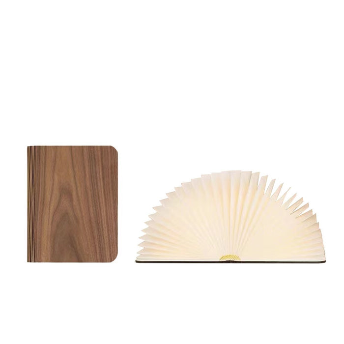 Walnut wood book lamp, closed and open with warm LED light, showcasing its unique design.
