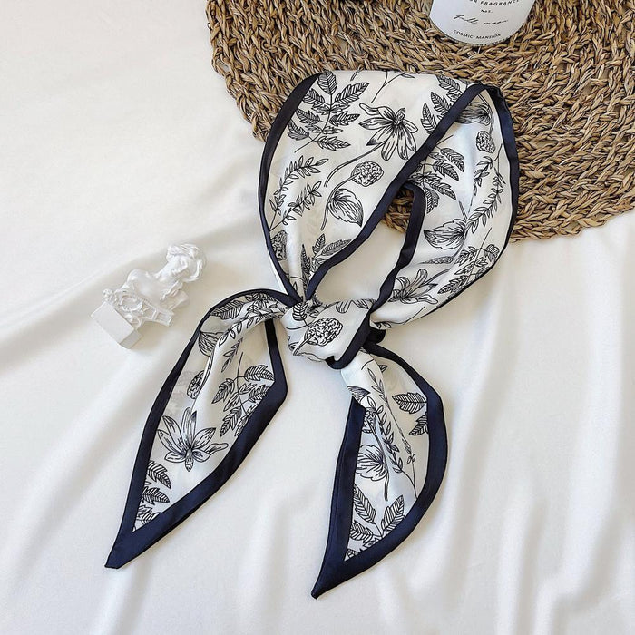 Folded view of Botanical Pattern Silk Scarf in silver and black, easy for travel packing and gifting.
