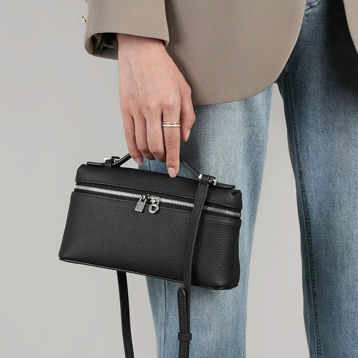 Model carrying a black bag handheld, great for daily carry and travel.
