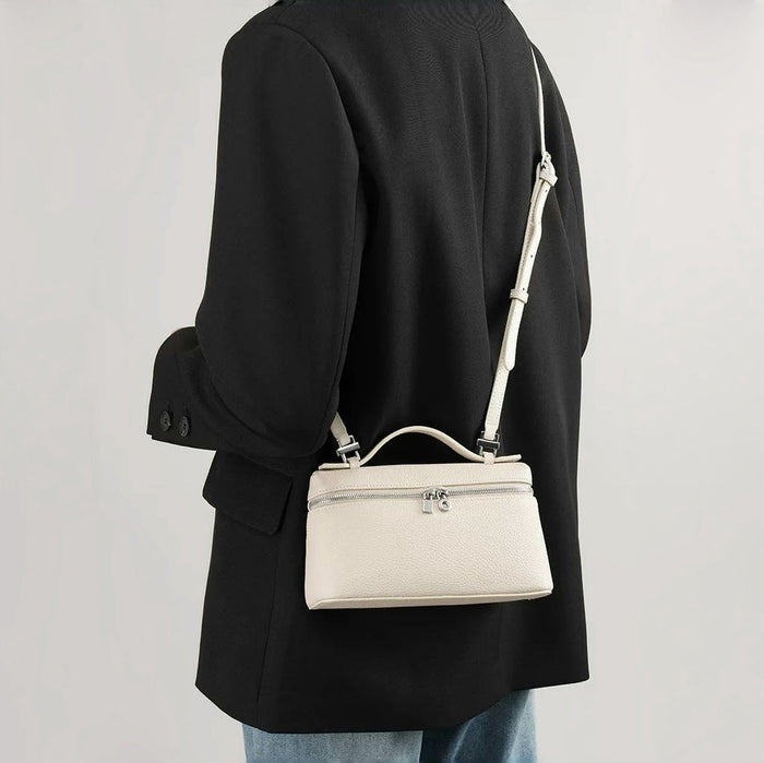 Model carrying a white bag as crossbody, easy for commuting and weekends.