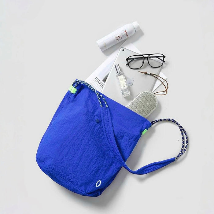 The interior of a Breezy Trail Bag with daily essentials like glasses and a notebook, highlighting its spacious size.