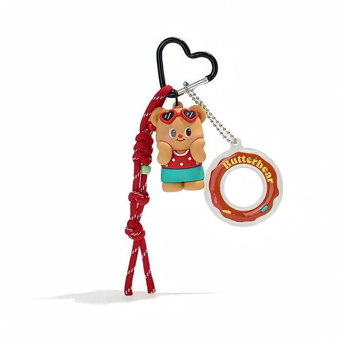 Flat lay of  Butter Bear Bag Charm with red rope and heart-shaped keyring, ideal for everyday outfits and street style.