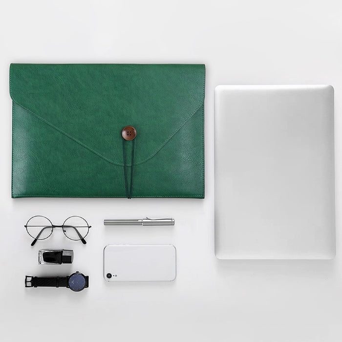 Folded view of Green PU leather file folder with button closure, next to a laptop, glasses, pen, phone, and watch.