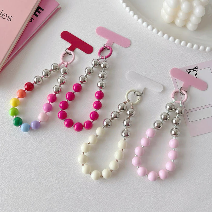Four acrylic candy bead phone charms in rainbow, pink, rose red and crean white.