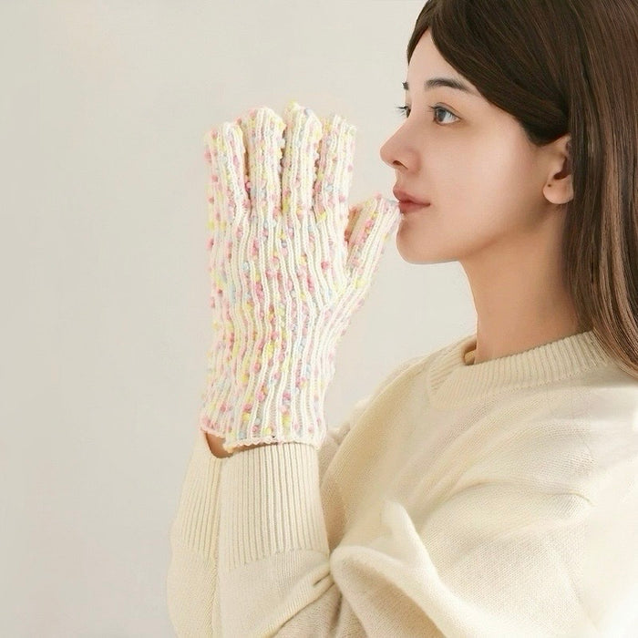 Model wearing cream candy-dot knit gloves with multicolor raised dots; soft knit for cold-weather outings.