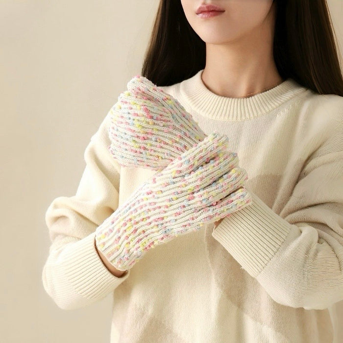 Model wearing cream candy-dot knit gloves with multicolor dot texture; cute accessory for chilly days.