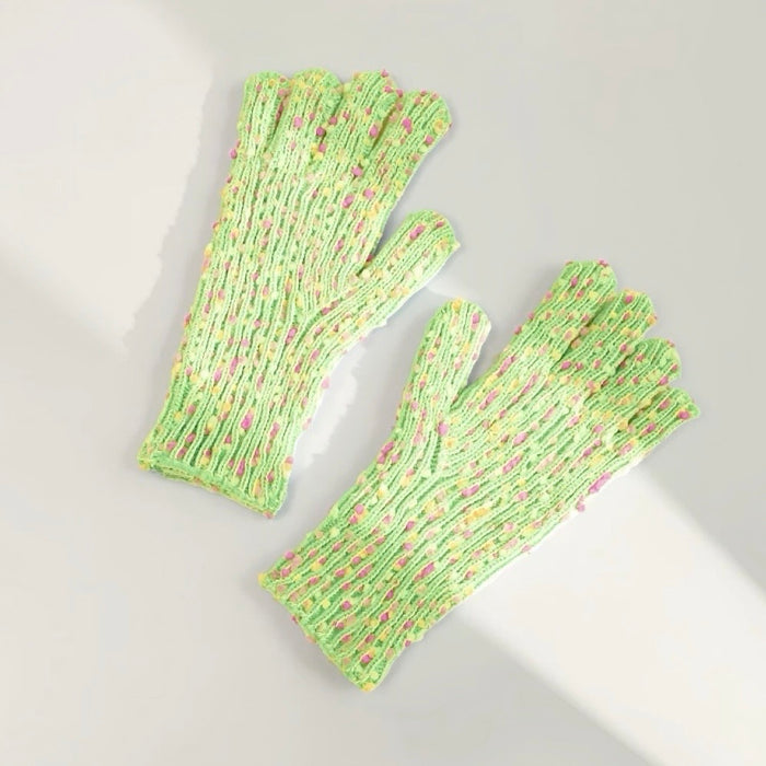 Green candy-dot knit gloves with raised dot texture and ribbed cuffs; playful warmth for everyday wear.