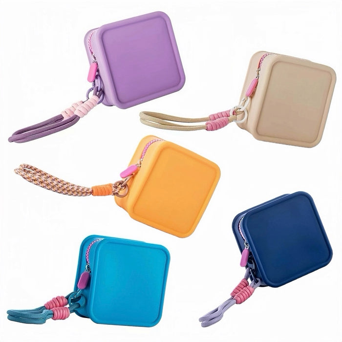 Flat lay of 5 small size vibrant shades of the silicone travel pouches showing the matching colorful wristlet cords.