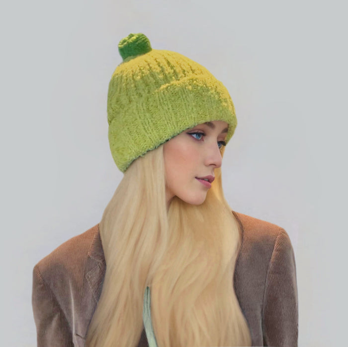 Side view of model wearing Candy Knitted Pompom Beanie. Playful 3D pompom in soft blend.