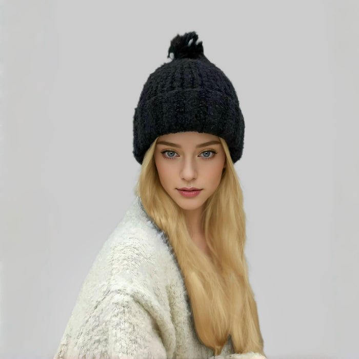 Model wearing black Candy Knitted Pompom Beanie. Playful 3D pompom detail in soft-touch knit.