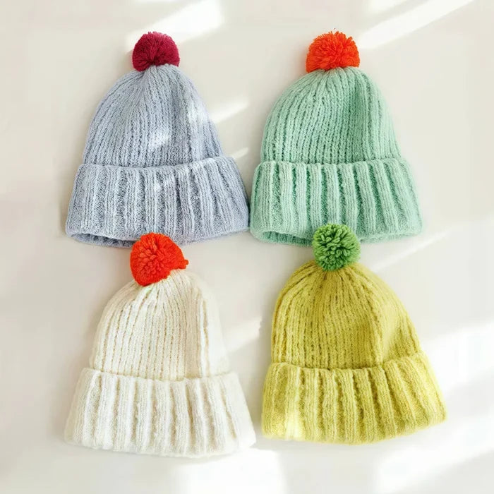 Front view of Candy Knitted Pompom Beanie. Playful 3D pompom detail in high-quality soft yarn.