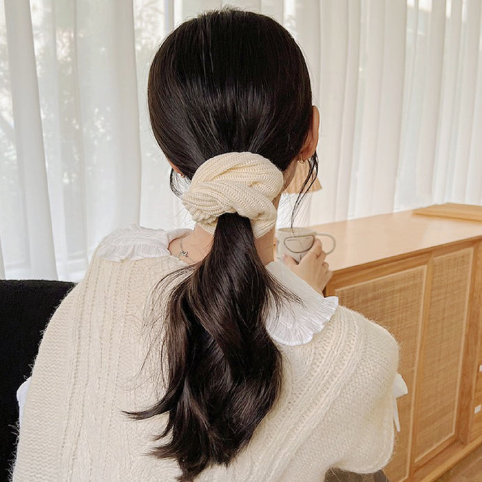 Model wearing a beige Knitted Scrunchie, ideal for quick updos and ponytails.