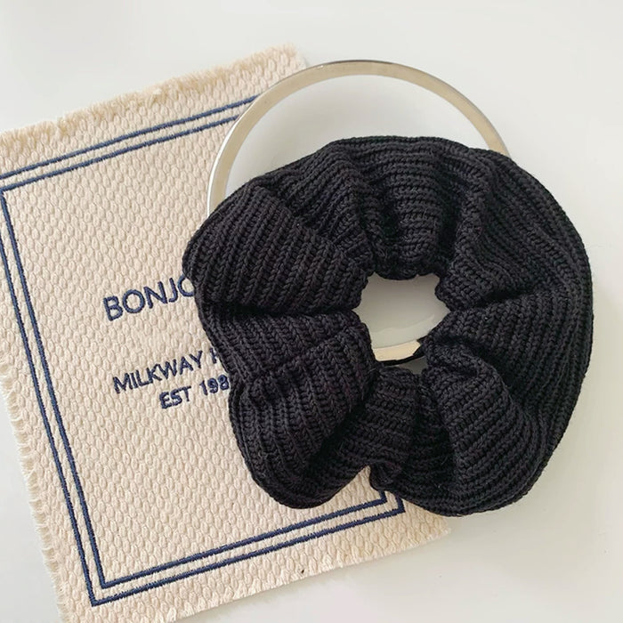Close-up of Candy Knitted Scrunchie in black, easy for workdays and special occasions.
