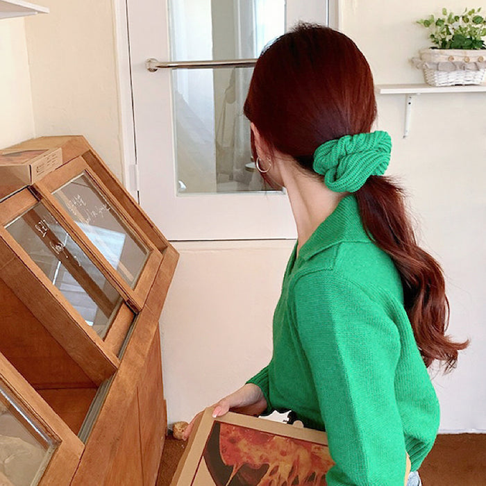 Model wearing a Candy Knitted Scrunchie in green, great for everyday styling and gifting.