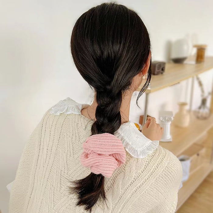 Model wearing a Candy Knitted Scrunchie in pink, easy for workdays and special occasions.