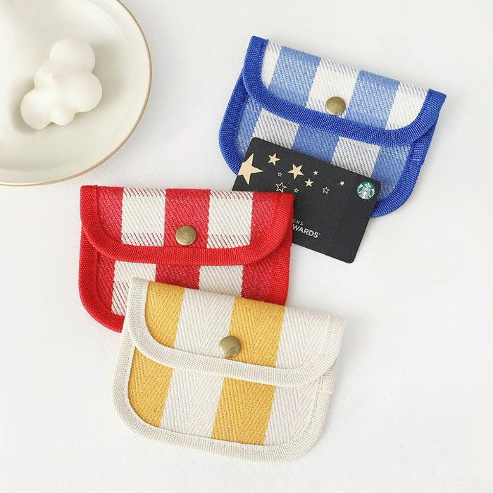 Canvas coin purses in blue gingham, red stripe and yellow gingham; snap-flap holders for cards and change.