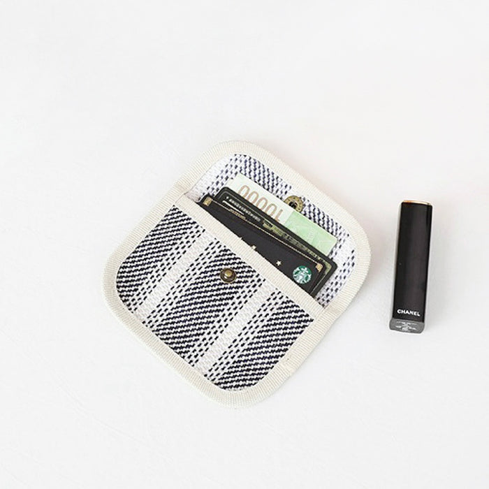 Black-and-white plaid canvas coin purse showing cards inside; snap-flap pocket wallet for travel and shopping.