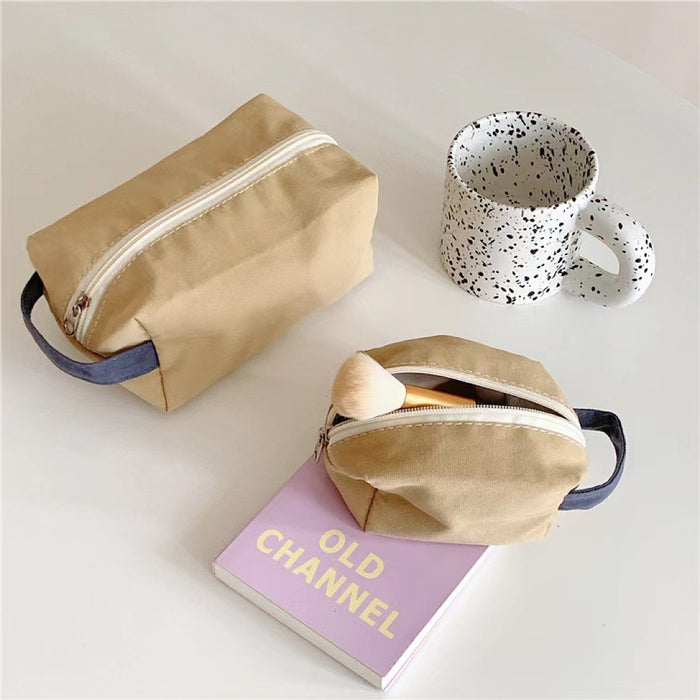Small and medium khaki canvas pouches shown together; versatile organizers for travel and daily carry.
