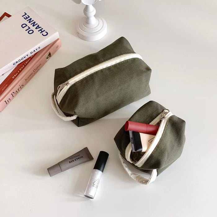 Interior view of olive green canvas makeup bags with small bottles; highlighting the spacious  capacity.