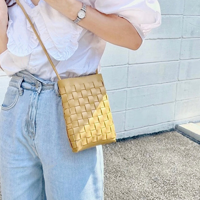 Model carrying a camel crossbody bag as crossbody, great for daily carry and travel.
