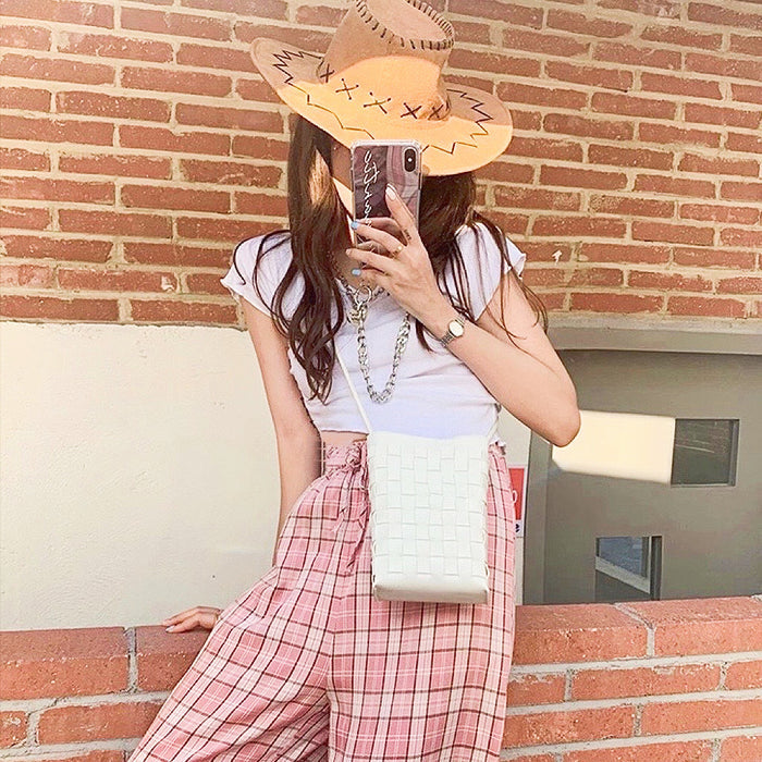 Model carrying a white crossbody bag as crossbody, easy for commuting and weekends.