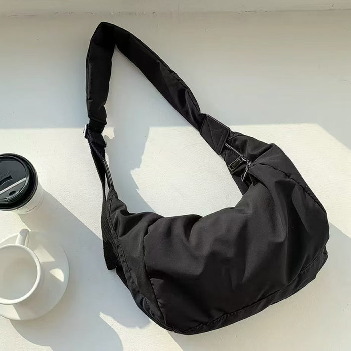 Black puffy nylon crescent bag with a spacious interior, perfect for organizing daily essentials.