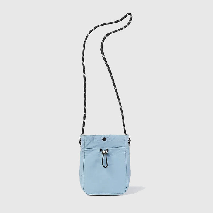 Folded view of a mini crossbody bag in blue, easy for commuting and weekends.