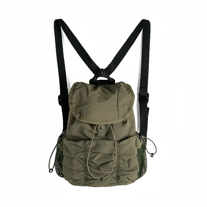 Olive green pleated backpack; durable nylon material suited for Gorpcore style and outdoor urban exploration.