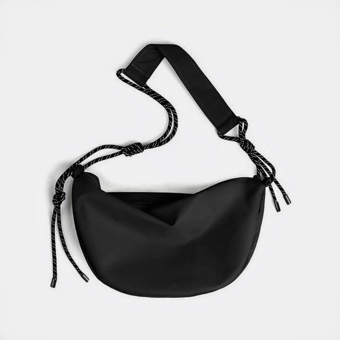 Front view of black knotted nylon crescent sling bag, highlighting the high-density ripstop material and zip-top.