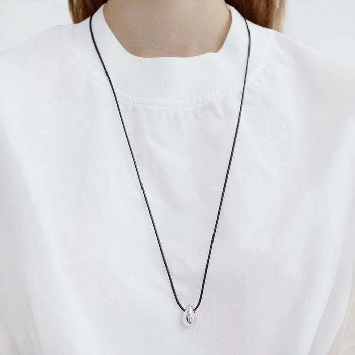 Model wearing silver Celestial Drop Pendant Necklace in Silver, minimalist elegant jewelry style.