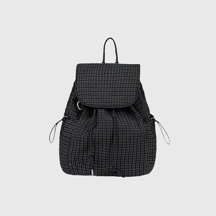 Flat lay of Check Mate Mini Backpack cotton bag in black, great for everyday carry and travel.