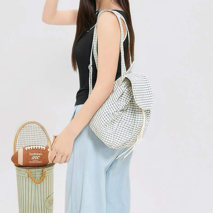 Model carrying a white Check Mate Mini Backpack on the shoulder, easy for commuting and weekends.