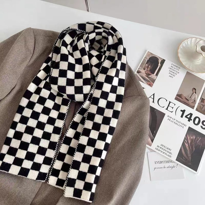 Close-up of a plaid scarf in black and white over a brown blazer, easy for weekend styling and gifting.