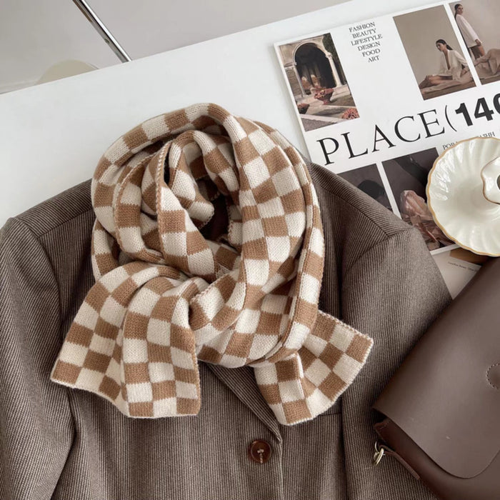 Close-up of  a plaid scarf in beige and khaki draped over a brown blazer, great for office layering and commuting.