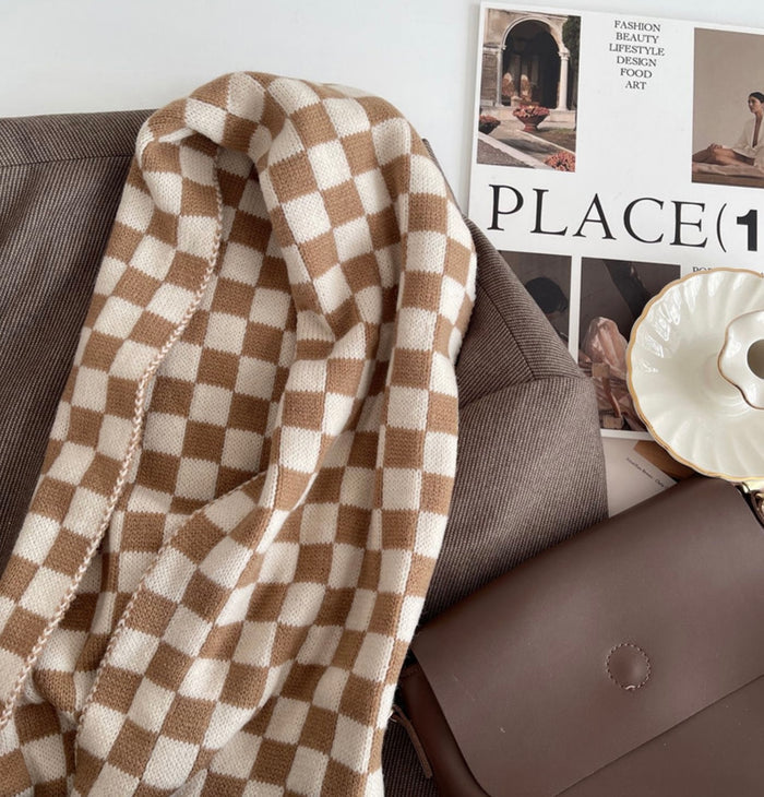 Close-up of a plaid scarf in beige and khaki over a brown blazer, easy for weekend styling and gifting.