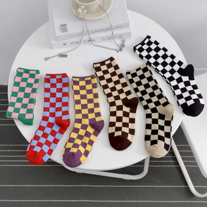 Front view of six pairs of colorful checkerboard socks in cotton-acrylic blend.