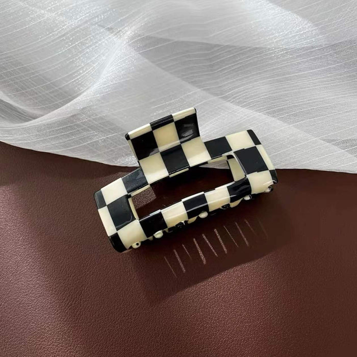 Angled view of checkerboard hair claw in rectangle shape, great for everyday styling and gifting.