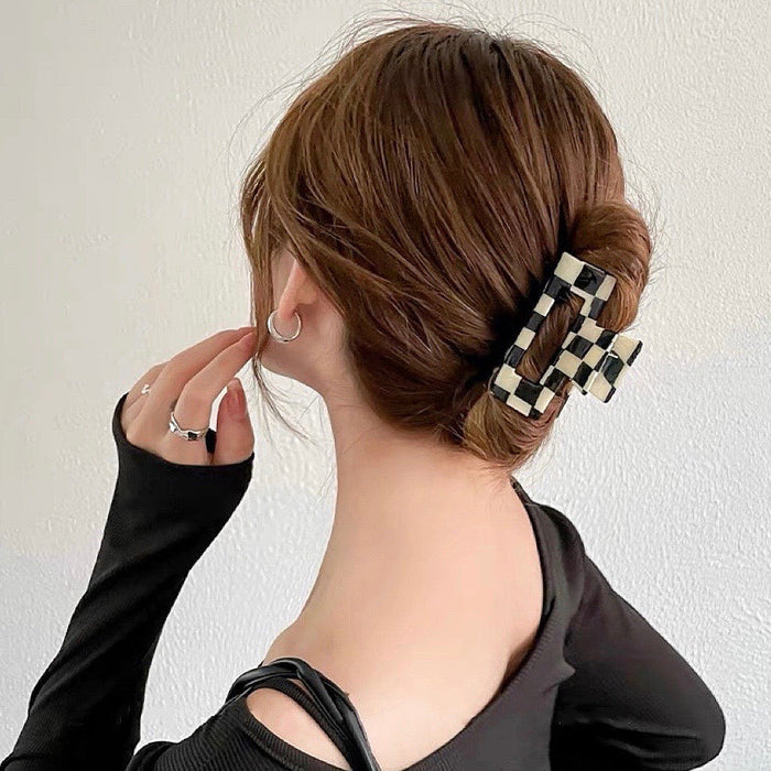 Model wearing checkerboard hair claw in rectangle shape, ideal for quick updos and ponytails.