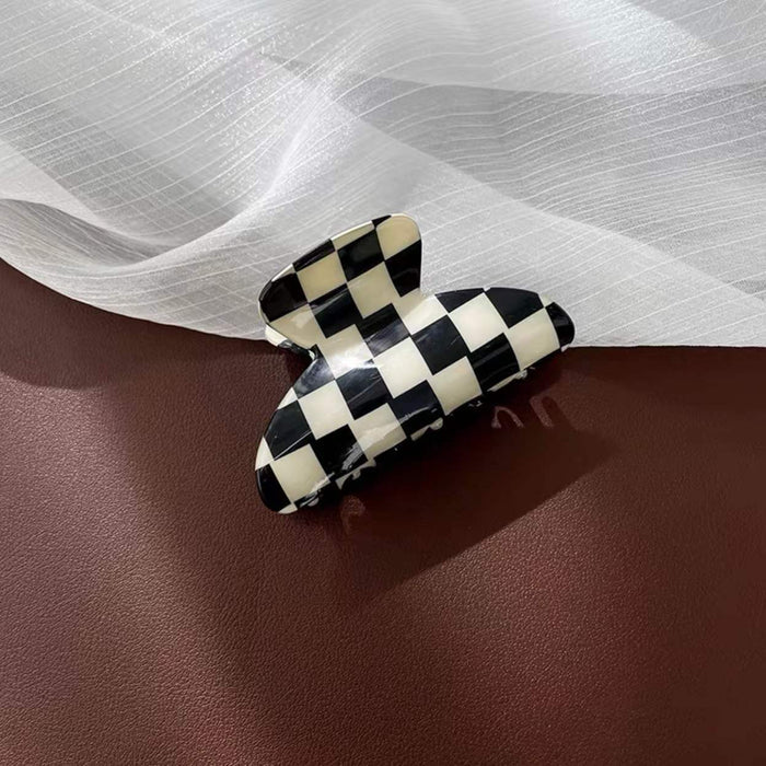 Front view of checkerboard hair claw in curve shape, easy for workdays and special occasions.
