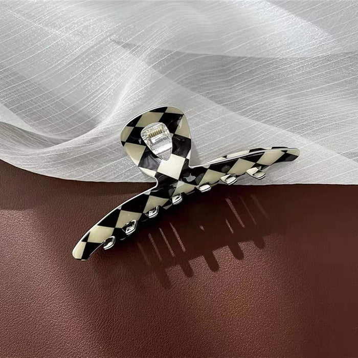 Close-up of checkerboard hair claw in line shape , ideal for quick updos and ponytails.